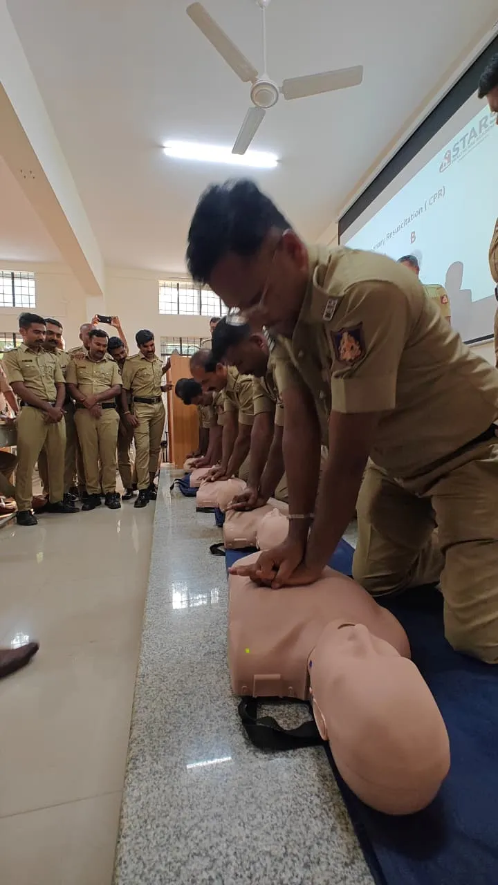 Police trainee performing CPR on a manikin